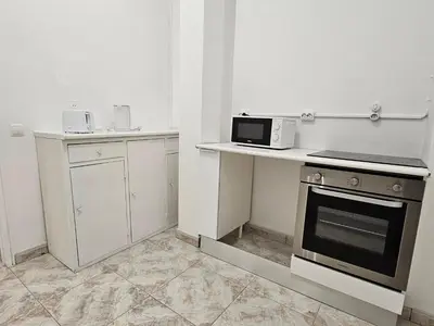 a kitchen with a stove and a microwave on a counter at Blife Brasilya - private rooms at Santantonya 2nd floor in Faro