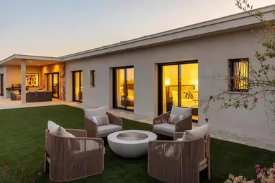 a house with a lawn with chairs and a toilet at Faro Luxury Home with Heated Pool and Garden in Faro