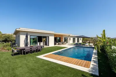a backyard with a swimming pool and a house at Faro Luxury Home with Heated Pool and Garden in Faro