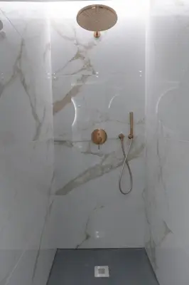 a white bathroom with a sink and a toilet at The View at the Downtown 5 in Faro