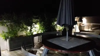 a table and an umbrella on a patio at Fantastic Apartment On The Beach in Albufeira