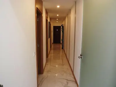 a hallway with a long corridor with a tile floor at Fantastic Apartment On The Beach in Albufeira
