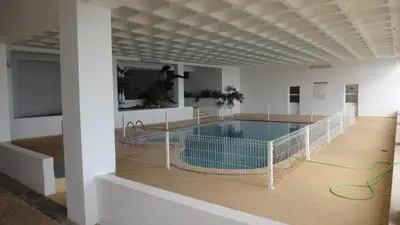 a large swimming pool in a building with a hose at Fantastic Apartment On The Beach in Albufeira