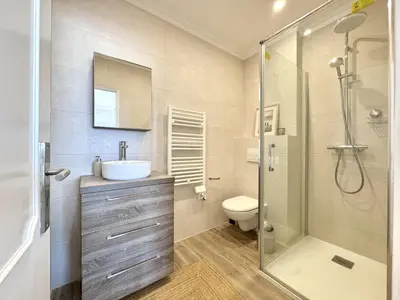 a bathroom with a toilet and a sink and a shower at Quarteira Central Beach 5 by Homing in Quarteira