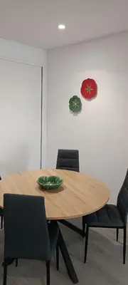a wooden table with chairs and a plate on it at Skynest 59 Faro Airport Guest House in Faro
