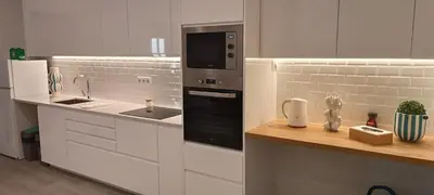 a white kitchen with a sink and a microwave at Skynest 59 Faro Airport Guest House in Faro