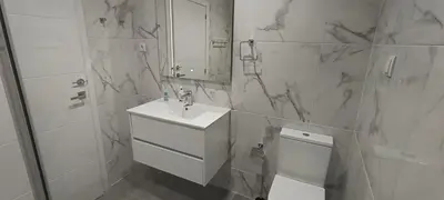 a bathroom with a sink and a mirror and a toilet at Skynest 59 Faro Airport Guest House in Faro