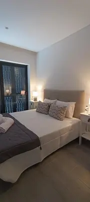 a bedroom with a large bed with two pillows on it at Skynest 61 Faro Airport Guest House in Faro