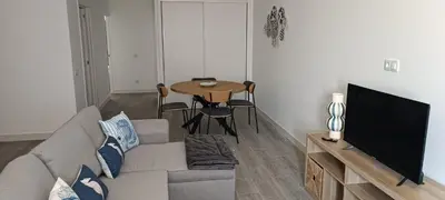a living room with a couch and a table at Skynest 61 Faro Airport Guest House in Faro