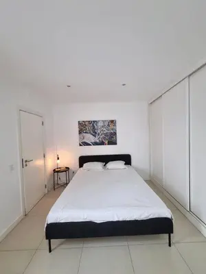 a bedroom with a large bed in a white room at Budget Beach Center - B4 in Albufeira