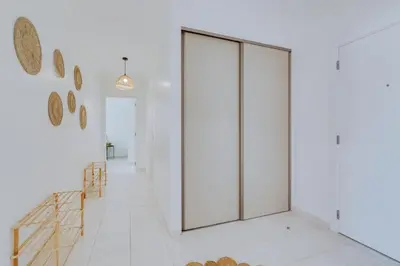 a hallway with white walls and a sliding door at Brisa Algarvia 1 in Faro
