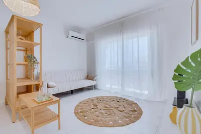 a living room with a couch and a table at Brisa Algarvia 1 in Faro