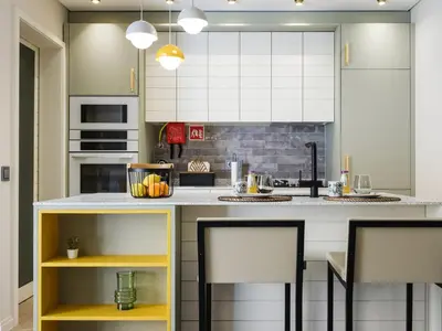 a kitchen with white cabinets and yellow accents at Apartamento T1 Luxo Marina Vilamoura in Vilamoura