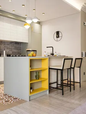 a kitchen with a yellow and white counter and chairs at Apartamento T1 Luxo Marina Vilamoura in Vilamoura