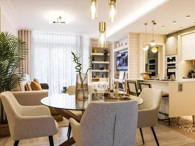 a dining room and living room with a table and chairs at Apartamento T1 Luxo Marina Vilamoura in Vilamoura