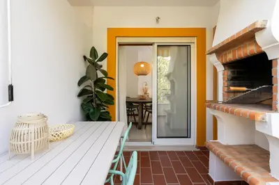 a porch with a table and a dining room at 1 Bedroom apt with pool access in Albufeira