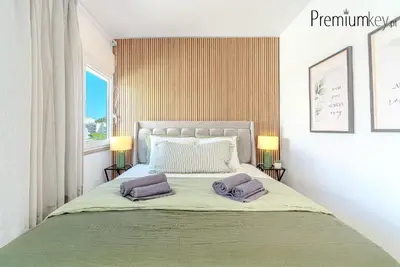 a bedroom with a large bed with two pillows on it at Peneco Beach Apartment Old Town in Albufeira
