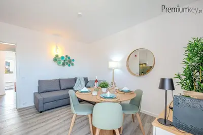 a living room with a table and chairs and a couch at Peneco Beach Apartment Old Town in Albufeira