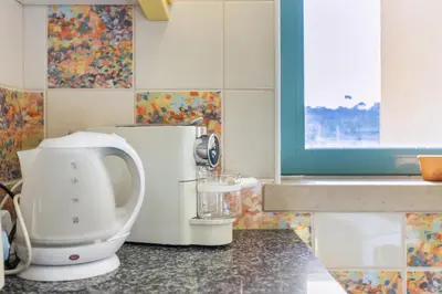 a kitchen with a white mixer on a counter at Marina Paradis Bleu in Albufeira