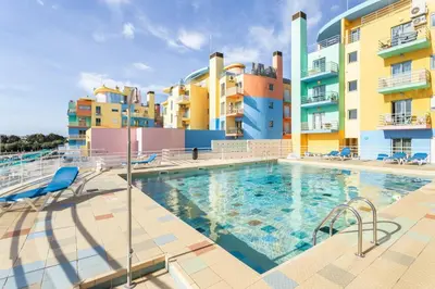 a swimming pool in front of some apartment buildings at Marina Paradis Bleu in Albufeira
