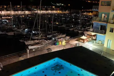 a view of a marina at night with boats at Marina Paradis Bleu in Albufeira