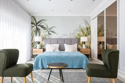 a bedroom with a bed and two chairs at Pedro Mar by Atlantic Places in Albufeira