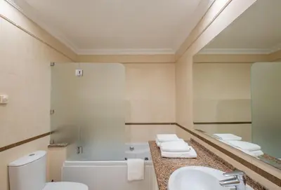a bathroom with a toilet and a sink and a mirror at Pedro Mar by Atlantic Places in Albufeira
