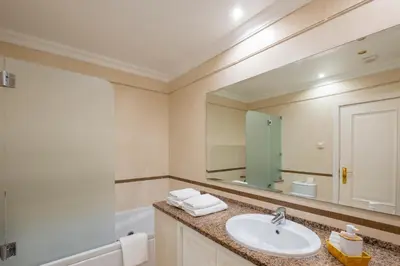 a bathroom with a sink and a mirror at Pedro Mar by Atlantic Places in Albufeira
