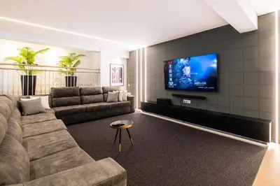 a living room with a couch and a flat screen tv at Pedro Mar by Atlantic Places in Albufeira