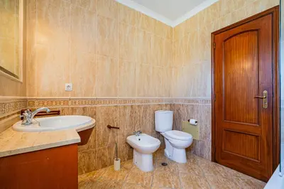 a bathroom with a toilet and a sink at Retiro dos Calicos by Dreamplaces in Albufeira