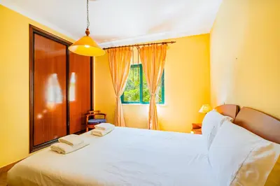 a bedroom with a white bed with two towels on it at Retiro dos Calicos by Dreamplaces in Albufeira