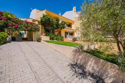 a house with a cobblestone street in front of it at Retiro dos Calicos by Dreamplaces in Albufeira