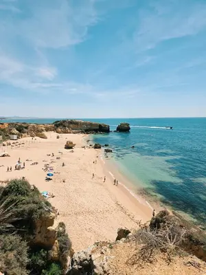 a group of people on a beach near the water at Casa Shiva in Albufeira