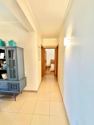 a hallway with a blue cabinet in a room at Apartamento 10 min da praia in Albufeira