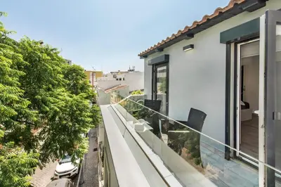 a balcony with a view of a house at Casa dos Quatro in Faro