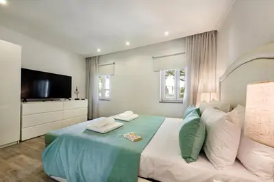 a bedroom with a bed with a flat screen tv at Casa dos Quatro in Faro