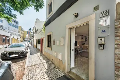 a car parked next to a building on a street at Casa dos Quatro in Faro