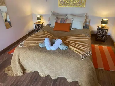 a bedroom with a bed with towels on it at Quinta Oriana Bella suite in Paderne