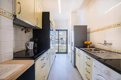 a kitchen with yellow cabinets and a sink at Casa Gale Mar in Galé