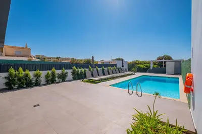 a swimming pool on a building with a patio at Casa Gale Mar in Galé