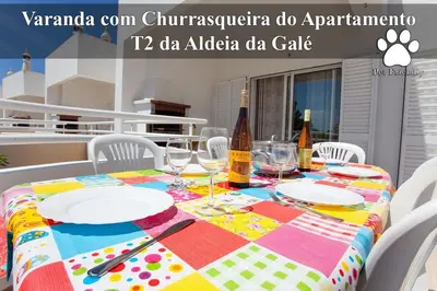 a table with wine bottles and plates on it at Os Apartamentos A Ramos na Praia da Galé Estão inserido em Condomínio com PISCINA, Fica apenas a 350 Metros da Praia da Galé - Apartamentos com Ar Condicionado tanto nos Quartos como na Sala, Smart TV com Prime Vídeo e Cozinha Completa in Albufeira
