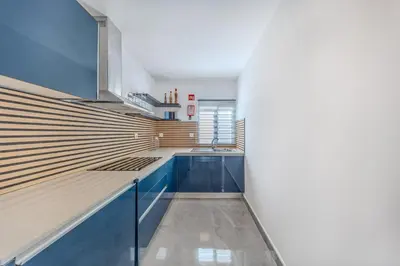 a kitchen with blue cabinets and a sink at Quinta Veigas in Medronhal