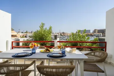a table with plates of food on a balcony at Vilamarina Elegance T2 Marina View Vilamoura in Quarteira