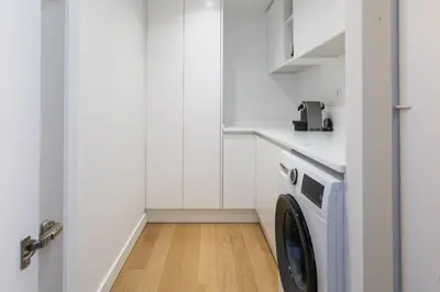 a laundry room with a washer and dryer at Vilamarina Elegance T2 Marina View Vilamoura in Quarteira