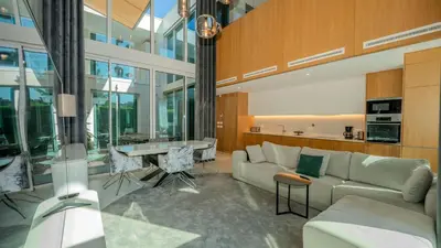a living room with a couch and a table at Central Vilamoura Casa A in Quarteira