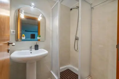 a bathroom with a sink and a shower at Sunny House with Jacuzzi and Pool by HostWise in Albufeira