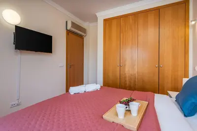 a bedroom with a bed with a tray with two cups at Sunny House with Jacuzzi and Pool by HostWise in Albufeira