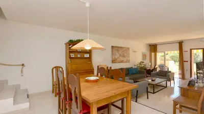 a dining room and living room with a table and chairs at Vilamoura Sul CD 312 - Cleverdetails in Quarteira
