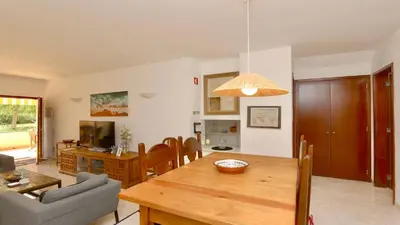 a dining room and living room with a table and a couch at Vilamoura Sul CD 312 - Cleverdetails in Quarteira
