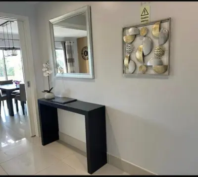 a room with a mirror and a black table at Pine Hills Vilamoura in Quarteira